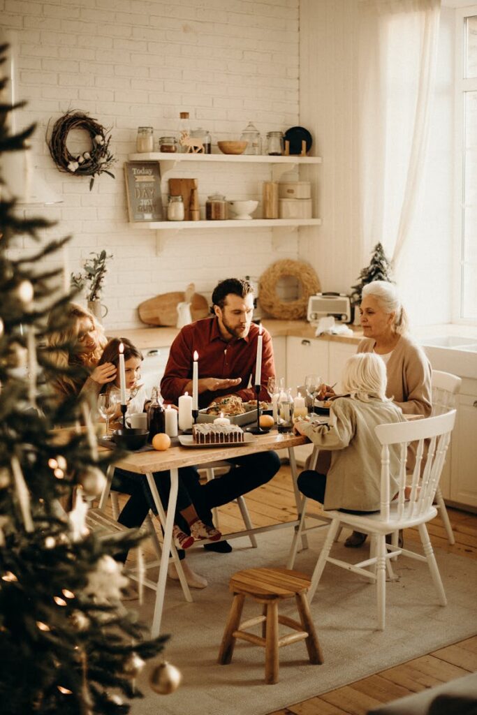 Warm family gathering around a festive dinner table during the holiday season, sharing food and joy.